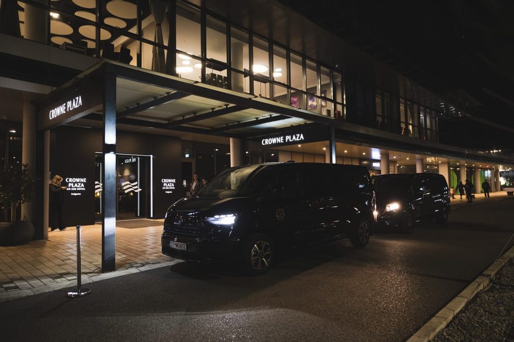 Monte Zeta van waiting under the entrance canopy of the Crowne Plaza hotel in Podgorica at night